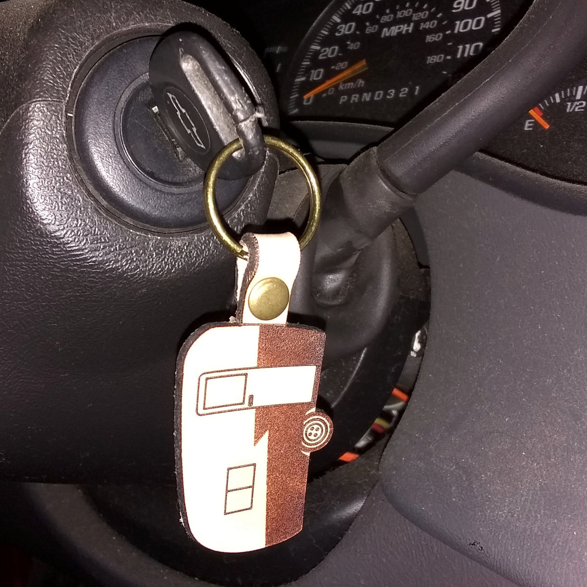Keychain attached to a car key in a car's ignition area