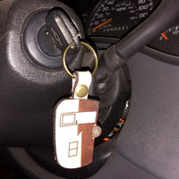 Keychain attached to a car key in a car's ignition area