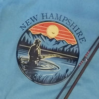 T-shirt with New Hampshire design featuring a person fishing at sunset.