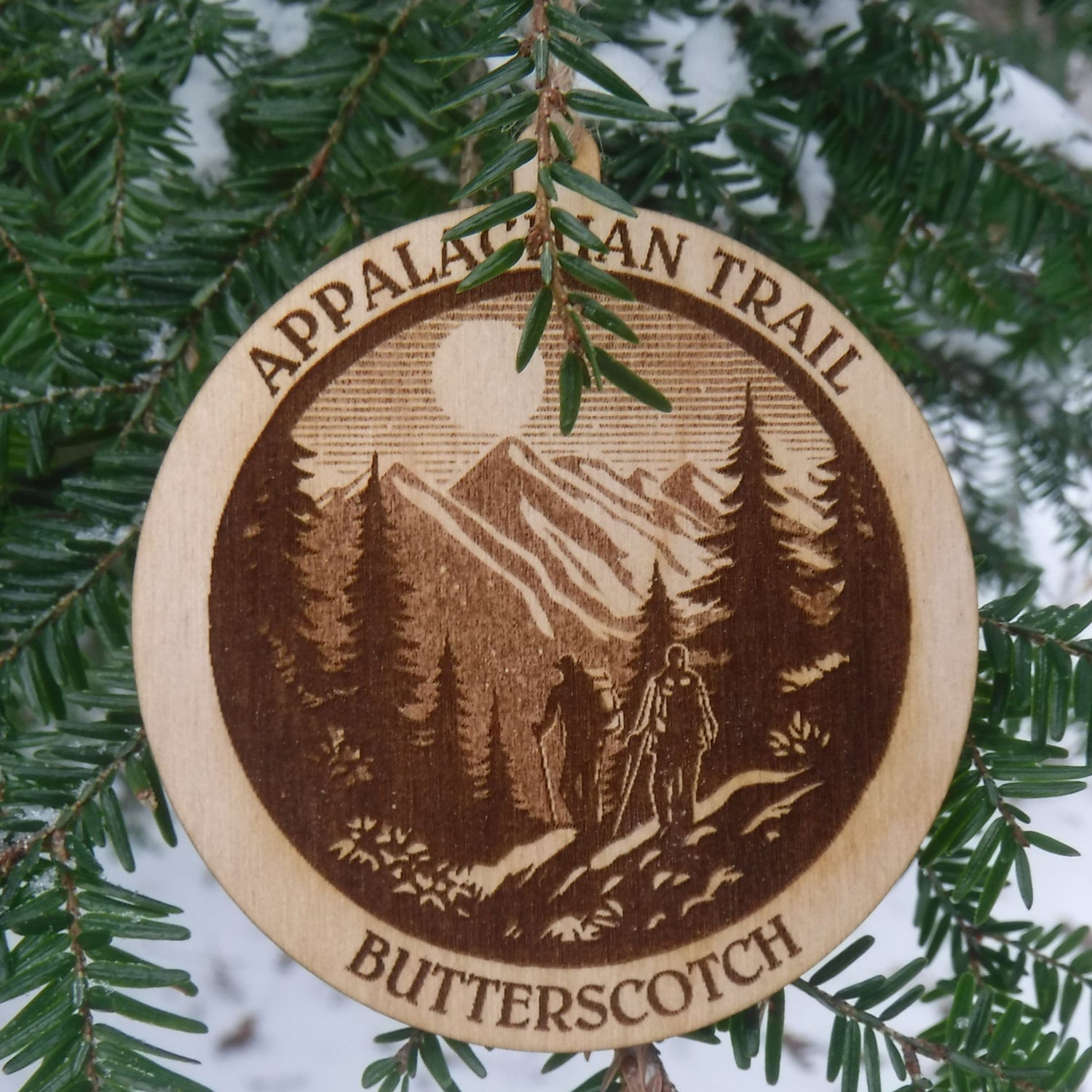 Wooden ornament with Appalachian Trail design on a tree branch