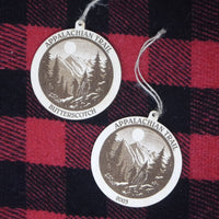 Two Appalachian Trail Butterscotch tags on a red and black plaid background