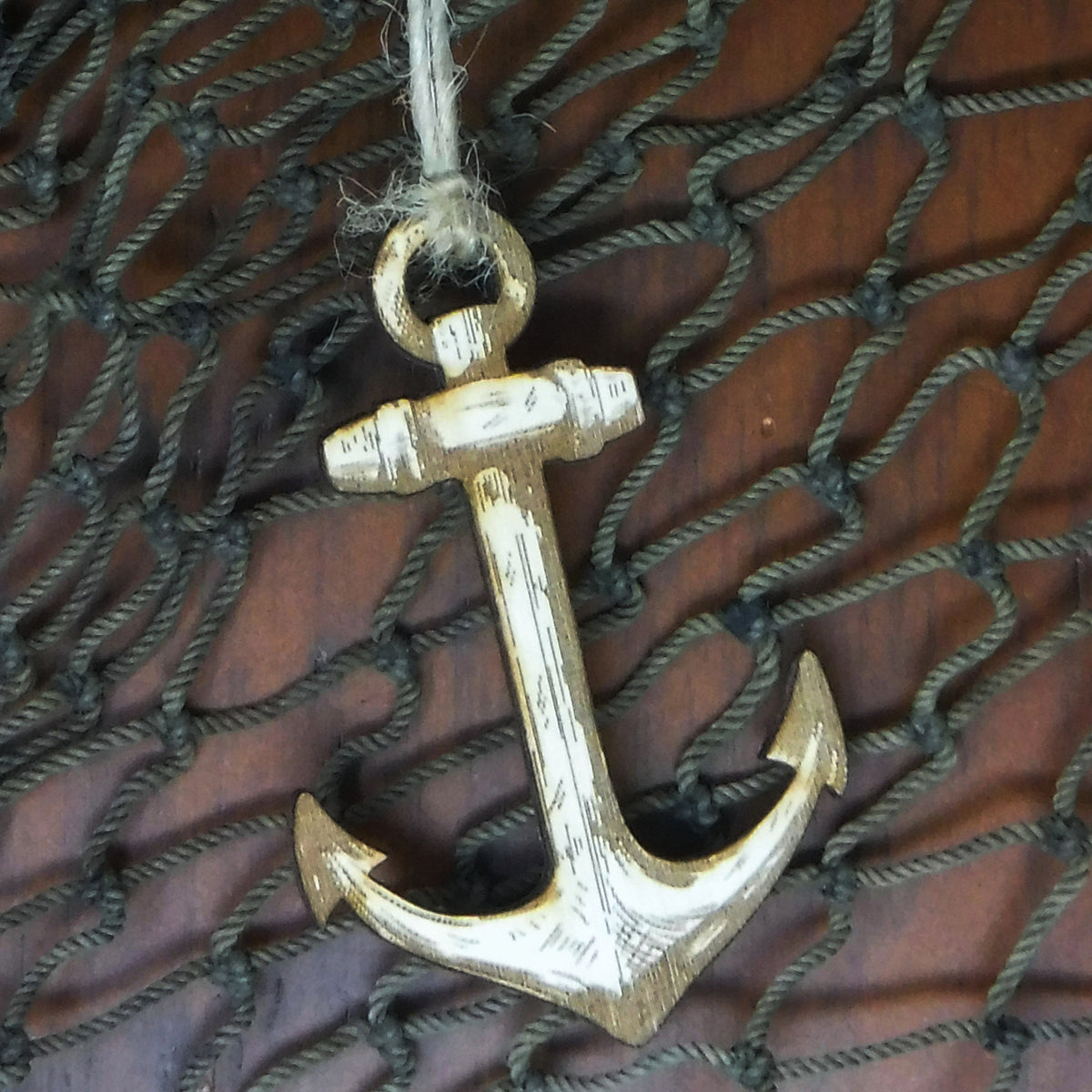 Wood anchor ornament on a textured brown background