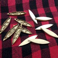 Wooden boat models on a red and black checkered fabric