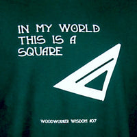 Green t-shirt with white text and triangle design on a dark green background