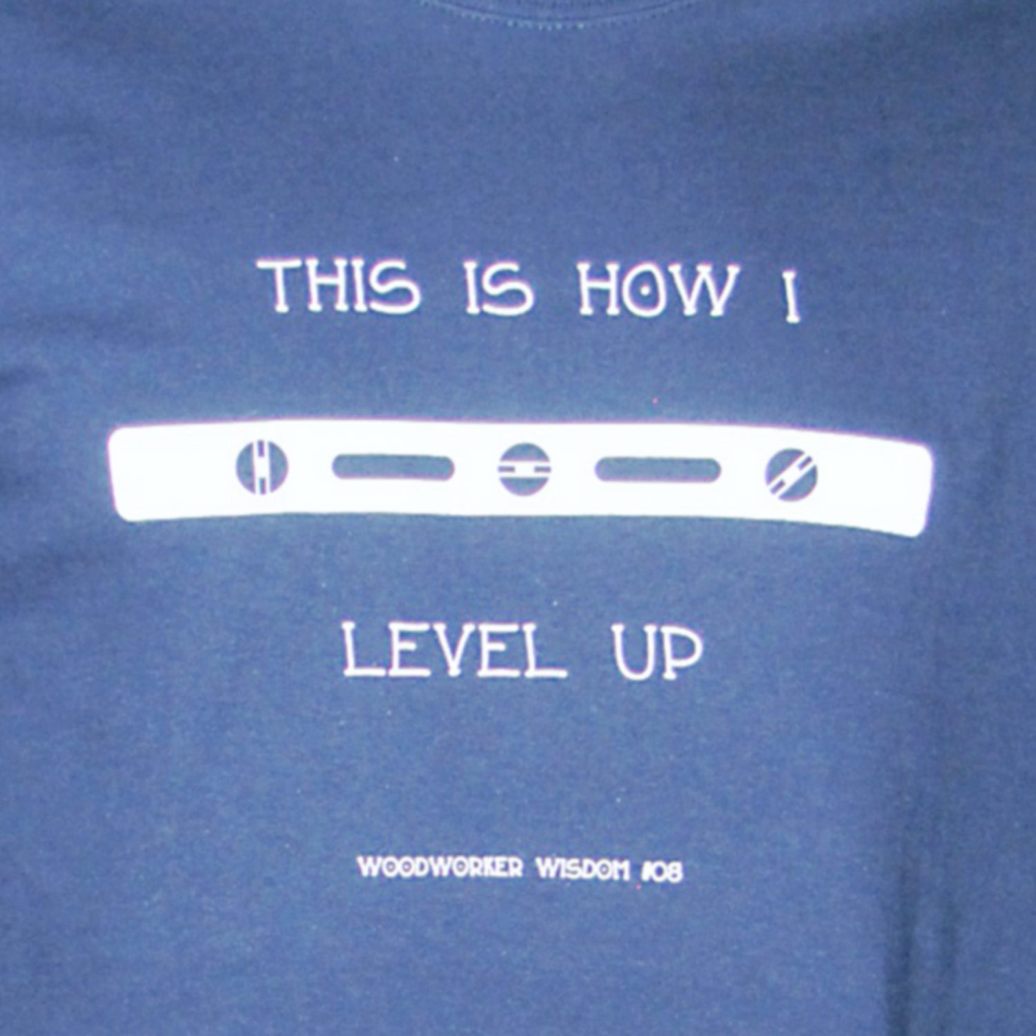 Blue t-shirt with white text and graphic design on a blue background