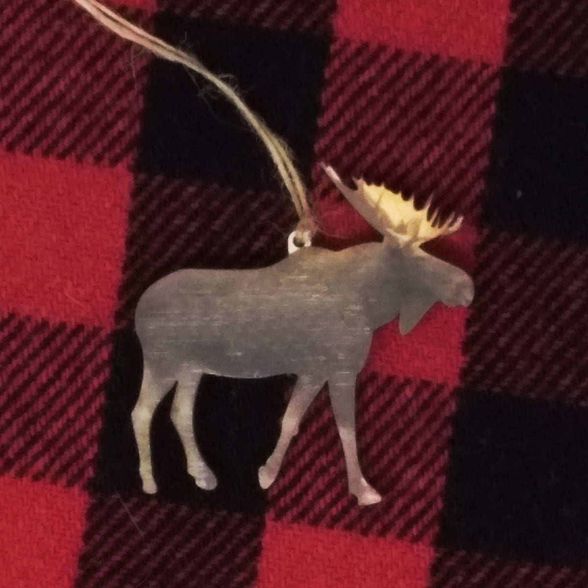 Moose ornament on a red and black checkered fabric background