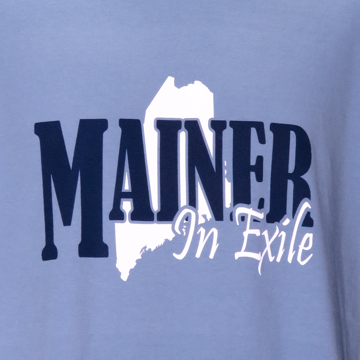 Blue t-shirt with 'MAINER In Exile' text and outline on a light blue background