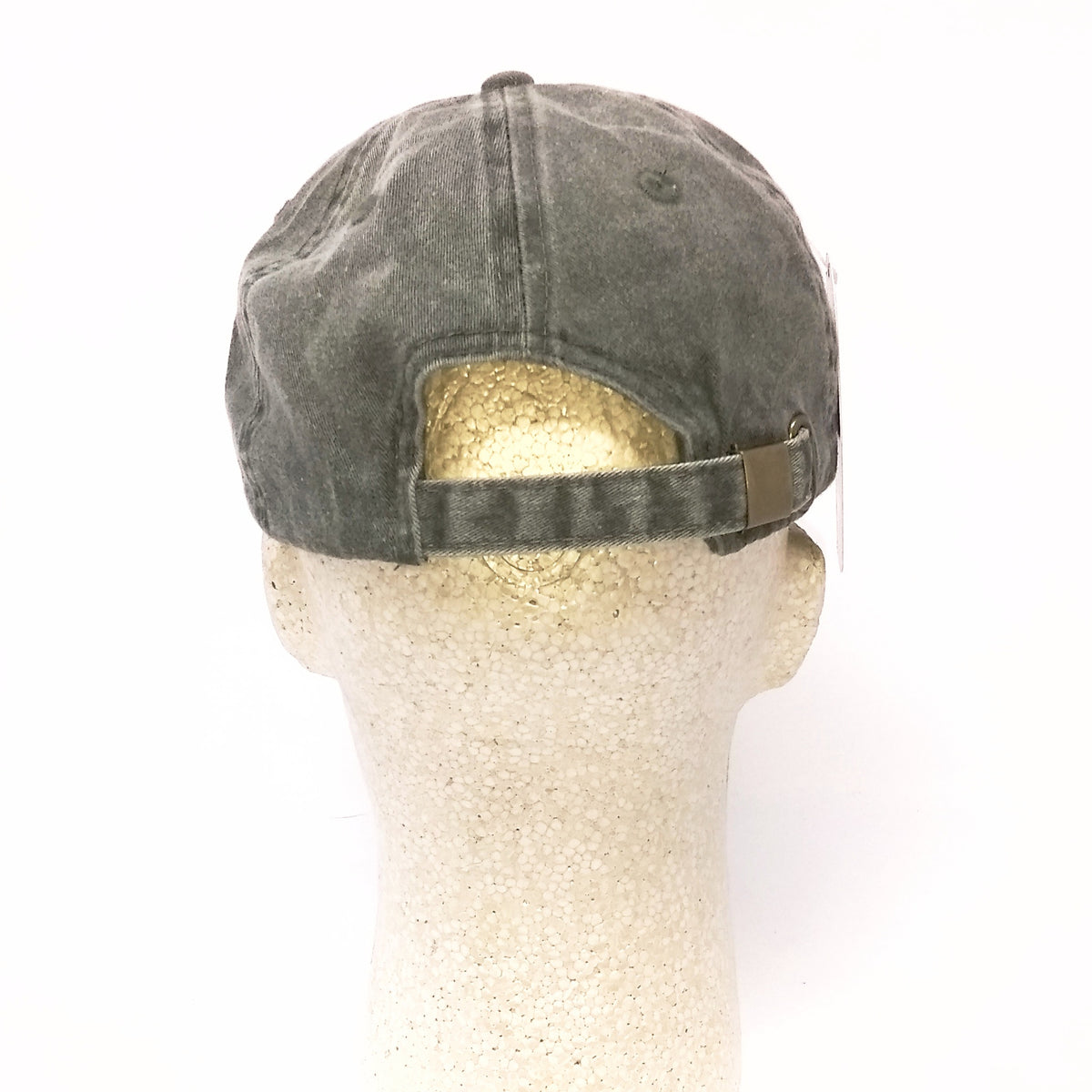 Green cap on a mannequin head against a white background