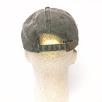 Green cap on a mannequin head against a white background