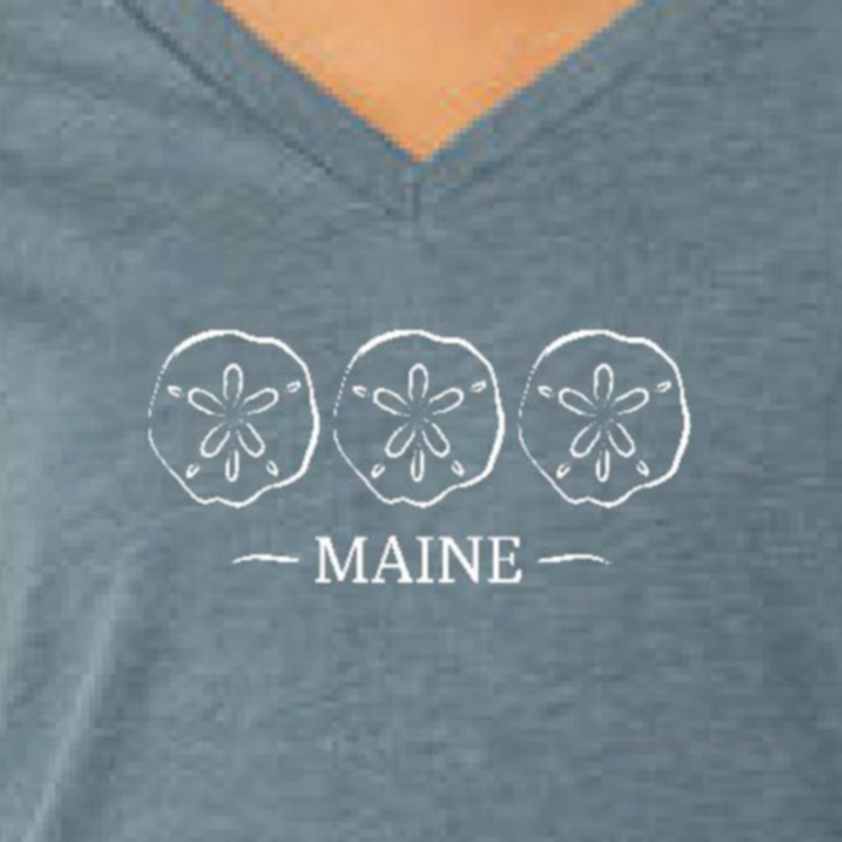 Blue V-neck shirt with sand dollar design and 'MAINE' text.