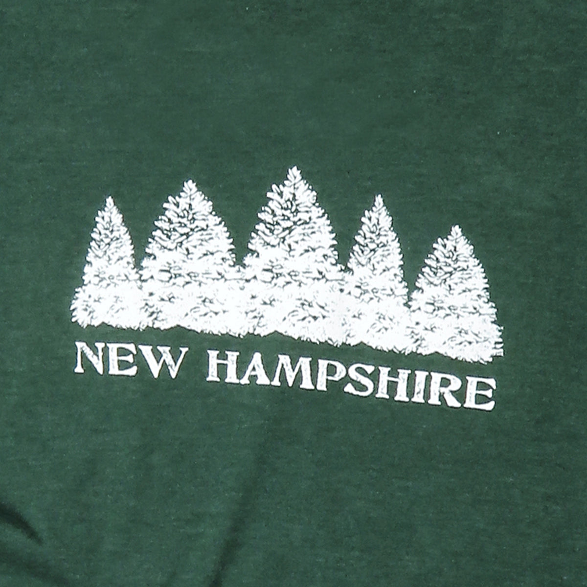 Green shirt with white tree design and 'New Hampshire' text