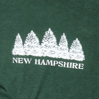 Green shirt with white tree design and 'New Hampshire' text