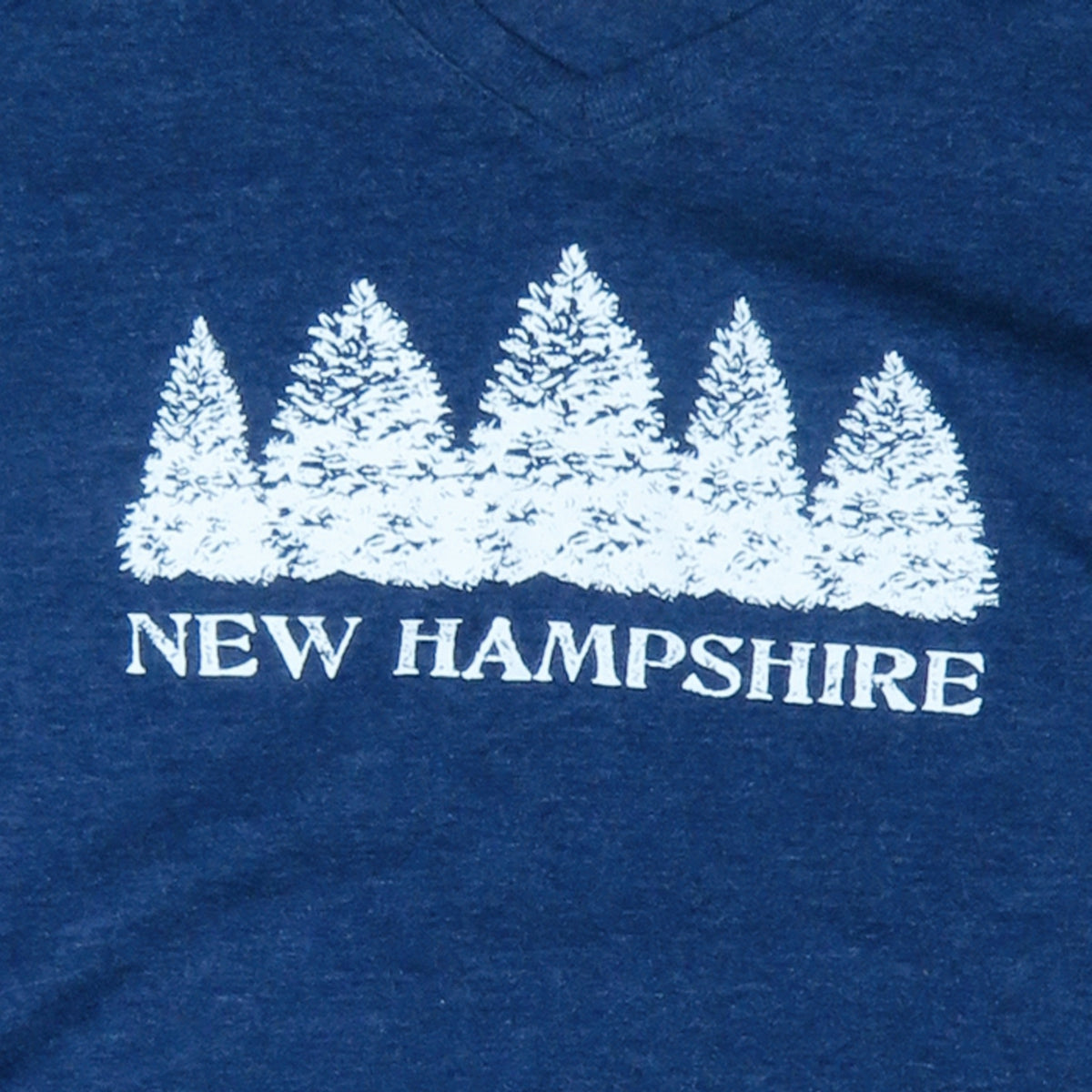 Blue t-shirt with white tree design and 'New Hampshire' text