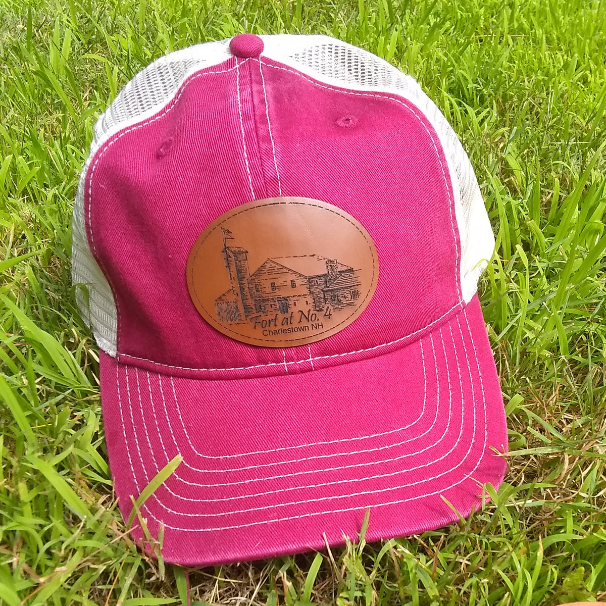 Red cap with a leather patch on grass