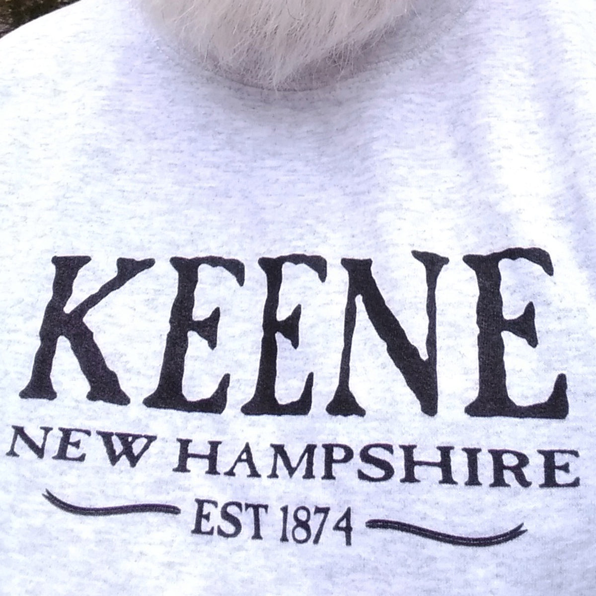 Grey sweatshirt with 'KEENE NEW HAMPSHIRE EST 1874' text on a white background