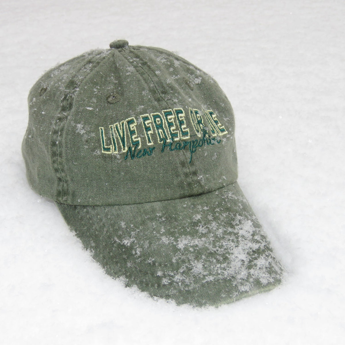 Green cap with 'Live Free or Die' text on a snowy background