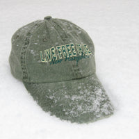 Green cap with 'Live Free or Die' text on a snowy background