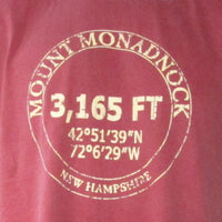 Red shirt with white text detailing Mount Monadnock's elevation and coordinates.