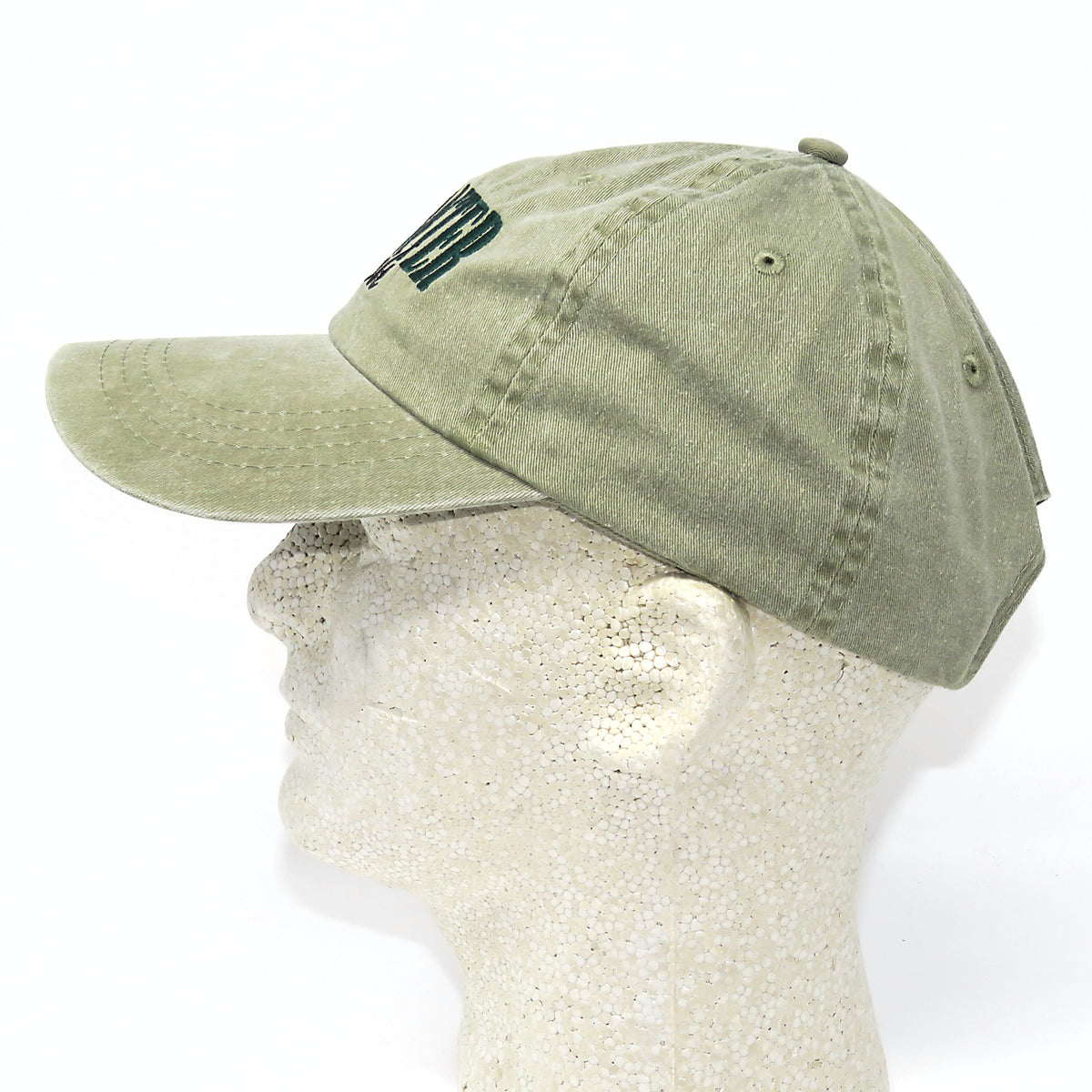 Green baseball cap on a mannequin head with a white background