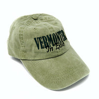 Green cap with 'VERMONTER In Exile' text on a white background