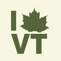 Green 'I Love VT' logo with a maple leaf on a beige background