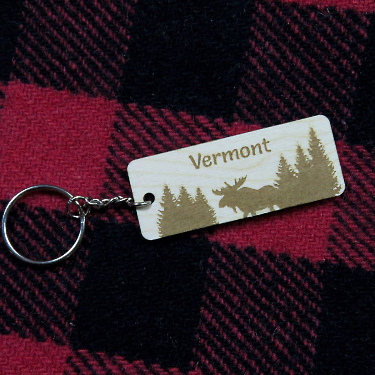 Keychain with 'Vermont' and moose design on a red and black plaid fabric background