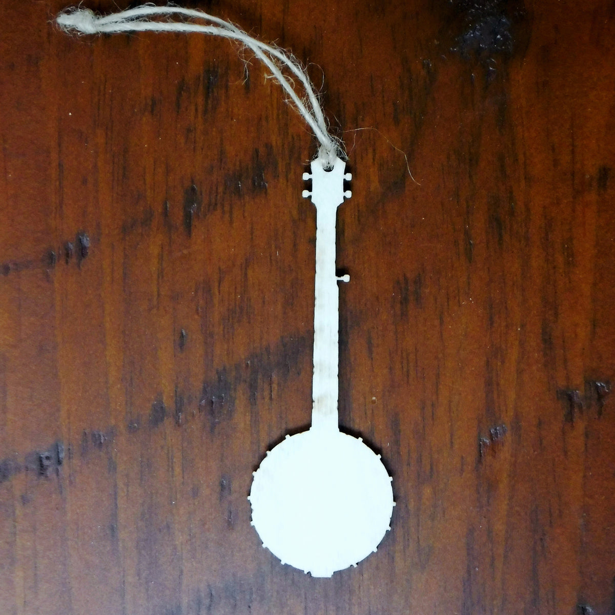 White banjo ornament on a wooden surface