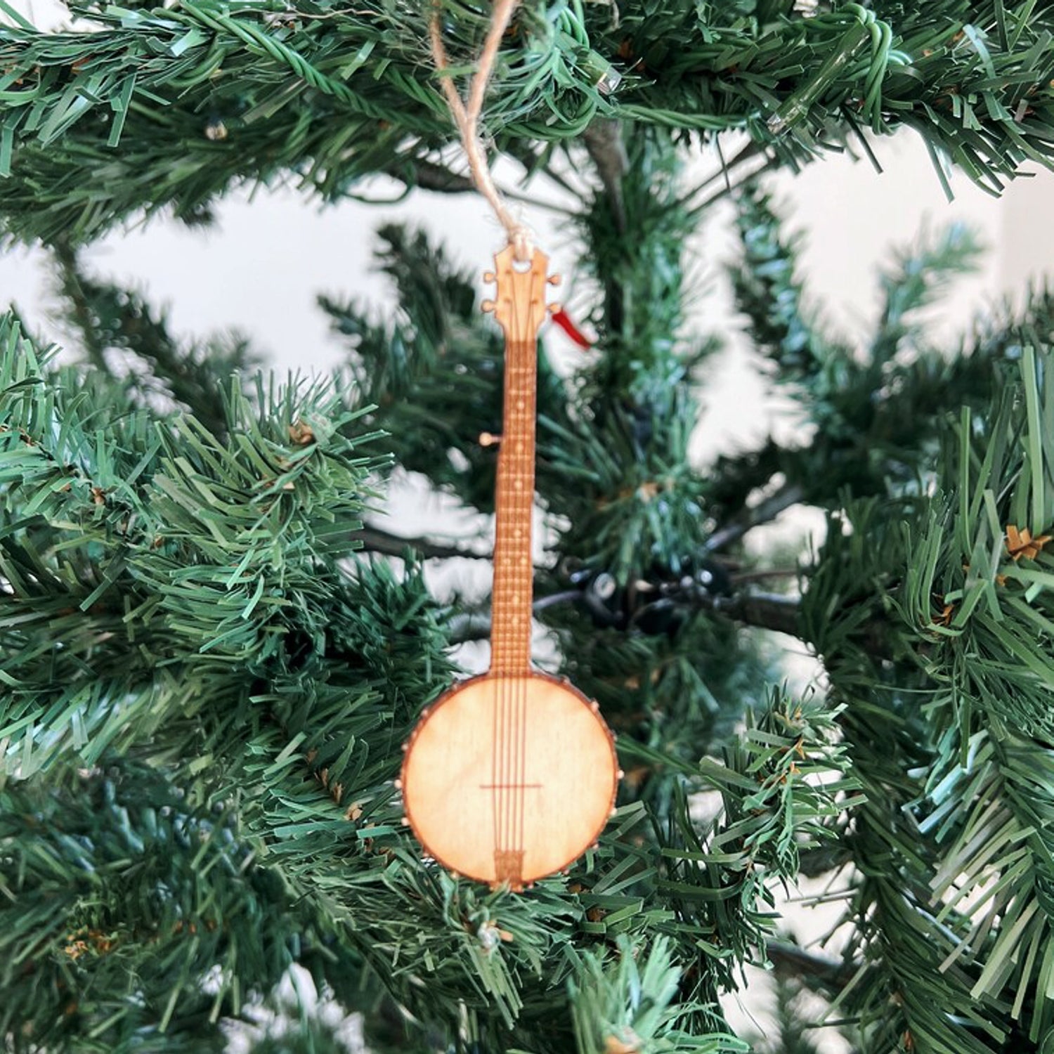 Banjo-shaped Christmas ornament hanging on a tree