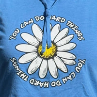 Blue hooded t-shirt with a white daisy and motivational text on a blue background