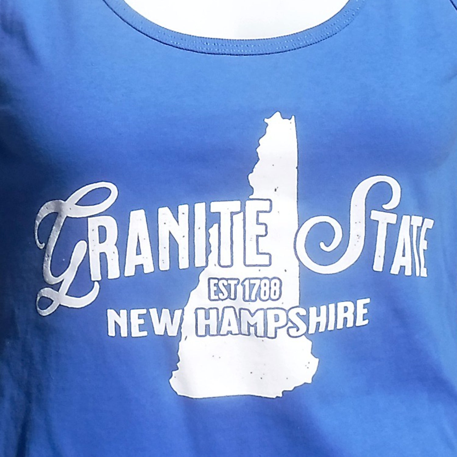 Blue t-shirt with white 'Granite State New Hampshire' text and state outline design.