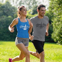 Two people running outdoors in a park with greenery in the background